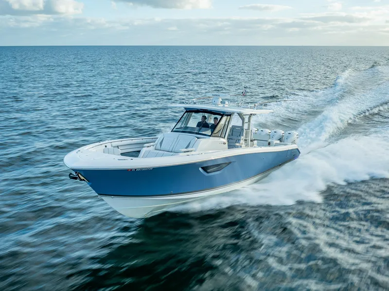Slide: The Image of 2022 Pursuit 428S boat cruising on open water. - 17