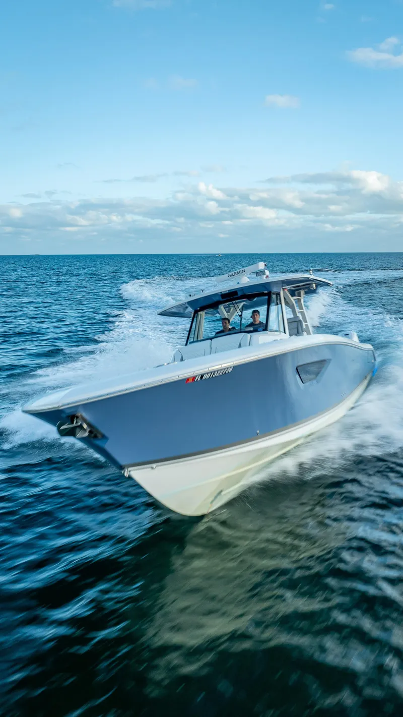 Slide: The Image of 2022 Pursuit 428S boat cruising on open water. - 20