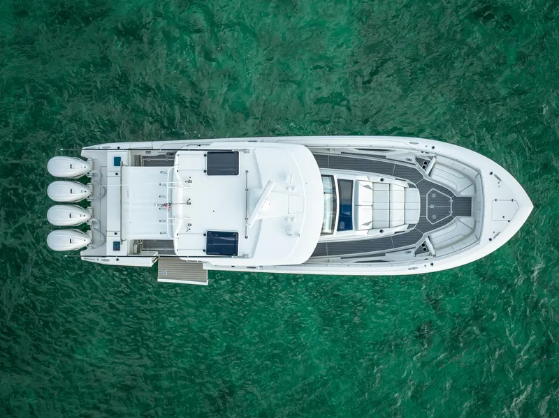 Slide: The Image of Aerial view of 2022 Pursuit 428S boat on clear green water. - 3