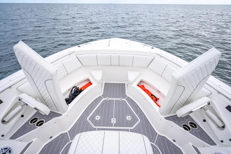 Slide: The Image of Bow seating area of 2022 Pursuit 428S boat on open water. - 30