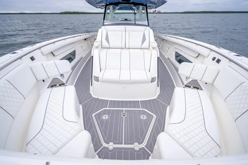 Slide: The Image of Luxurious 2022 Pursuit 428S boat interior with white seating and gray flooring. - 32