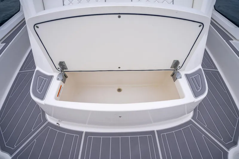 Slide: The Image of 2022 Pursuit 428S boat with open storage compartment on deck. - 34