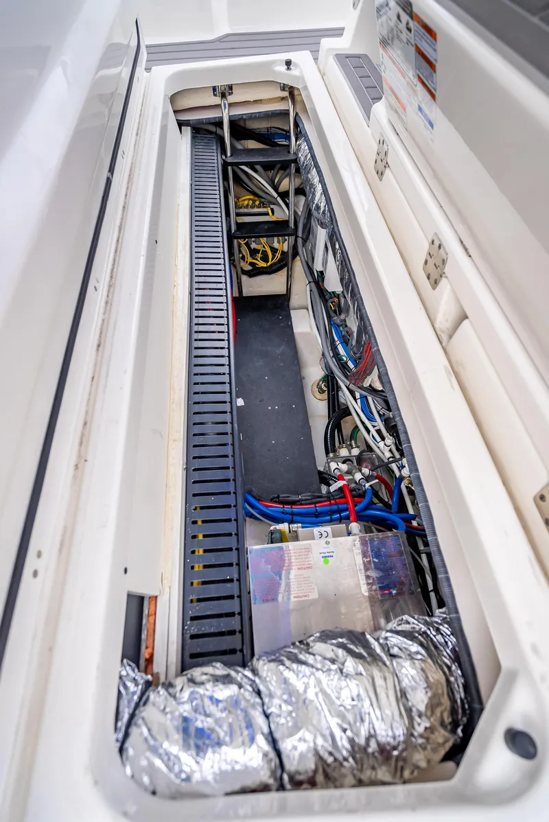 Slide: The Image of 2022 Pursuit 428S boat engine compartment with wiring and components. - 41