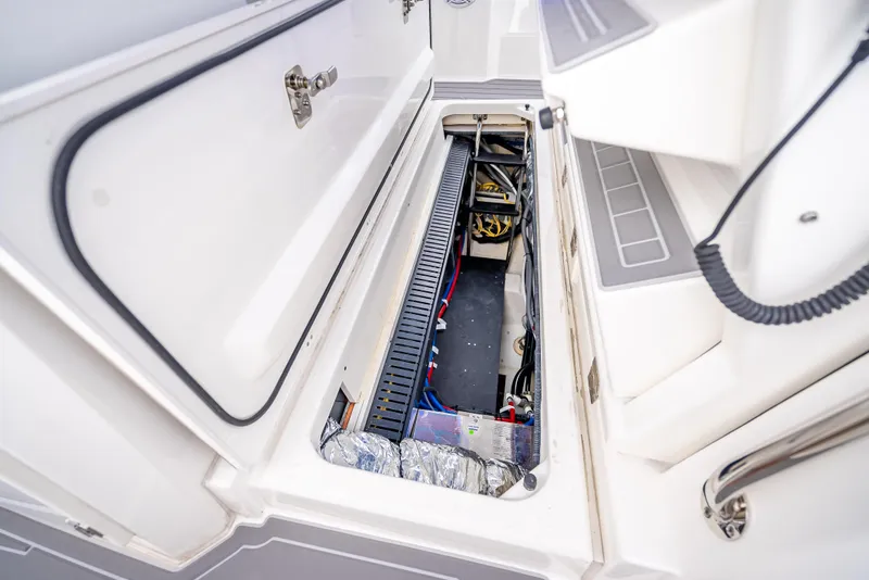 Slide: The Image of 2022 Pursuit 428S boat storage compartment with open hatch. - 42