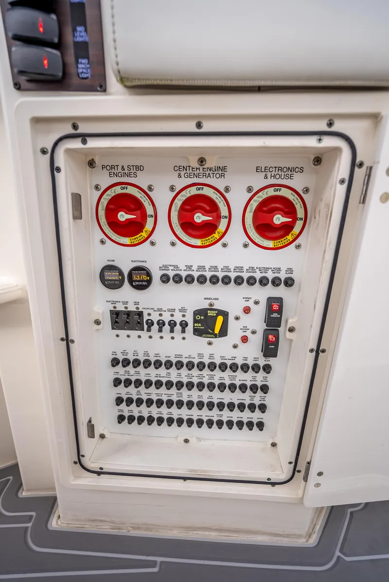 Slide: The Image of Control panel of a 2022 Pursuit 428S boat with various switches and dials. - 45