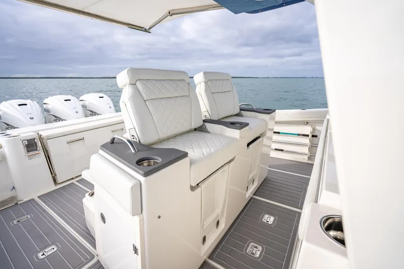 Slide: The Image of 2022 Pursuit 428S boat with luxurious seating and ocean view. - 47