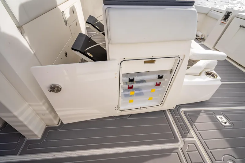 Slide: The Image of 2022 Pursuit 428S boat interior with open storage compartment and seating. - 49