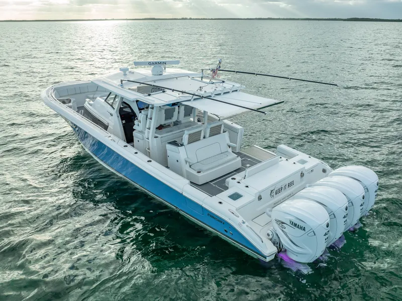 Slide: The Image of 2022 Pursuit 428S boat on open water with Yamaha outboard engines. - 9