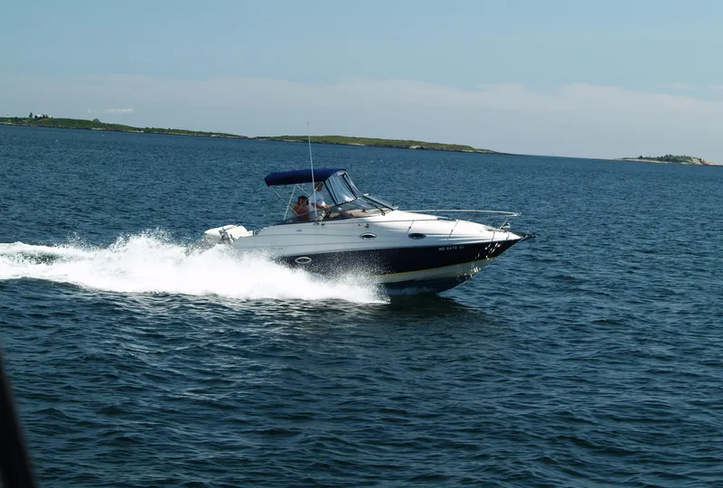 The Image of 2004 Regal 2665 Commodore Express cruising on open water. - 0