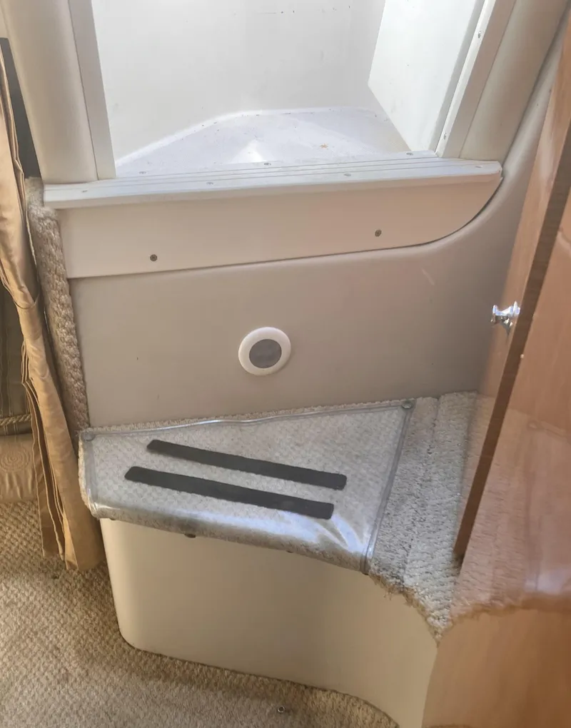 Slide: The Image of Interior step of 2004 Regal 2665 Commodore Express boat, featuring carpeted surface. - 24