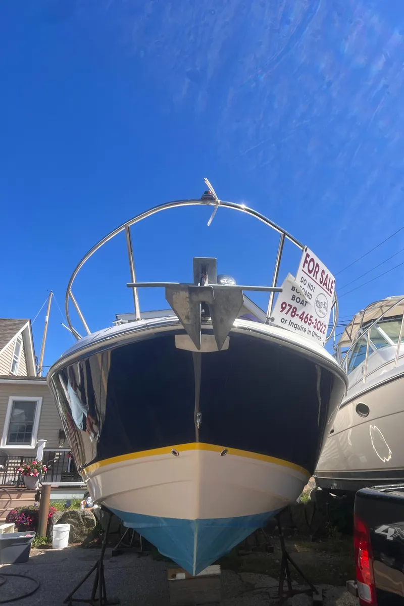 Slide: The Image of 2004 Regal 2665 Commodore Express boat for sale, displayed outdoors under a clear blue sky. - 3