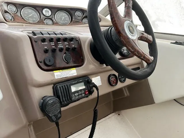 Slide: The Image of 2004 Regal 2665 Commodore Express boat dashboard with steering wheel and control panel. - 7