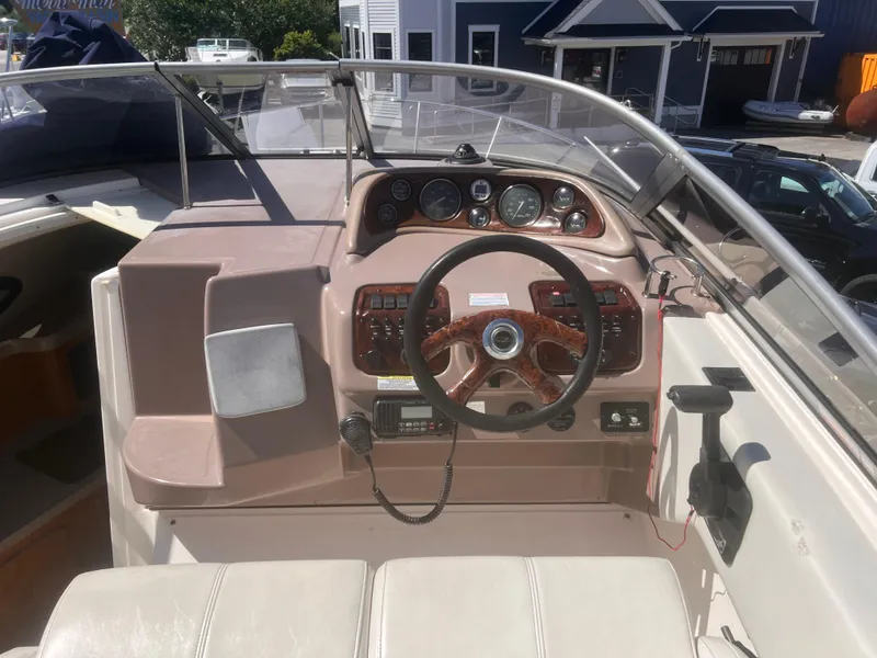 Slide: The Image of 2004 Regal 2665 Commodore Express boat cockpit with steering wheel and control panel. - 8