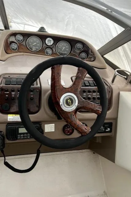 Slide: The Image of 2004 Regal 2665 Commodore Express boat dashboard with steering wheel and instrument panel. - 9