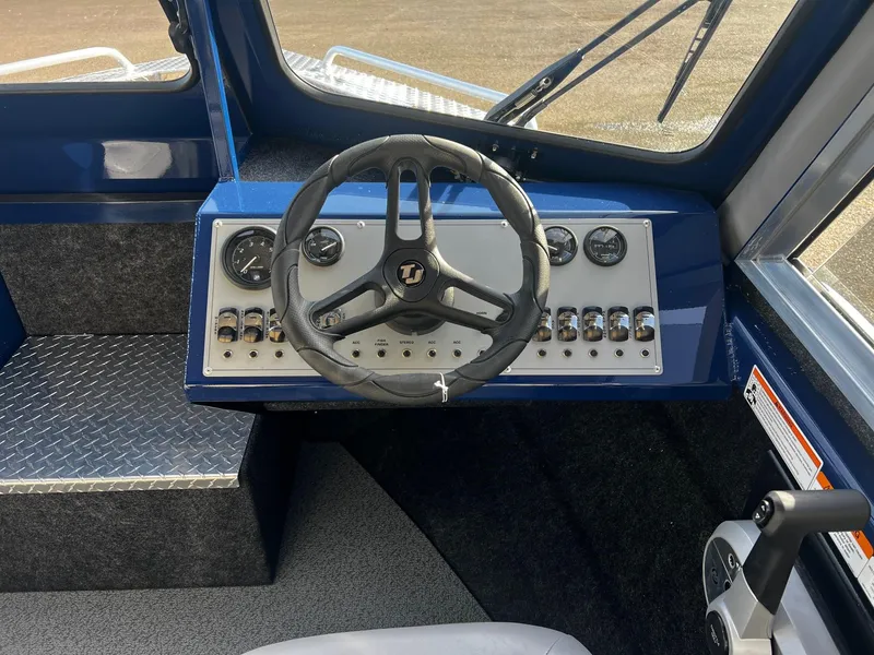 Slide: The Image of 2024 Thunder Jet 185 Luxor boat dashboard with steering wheel and control panel. - 10