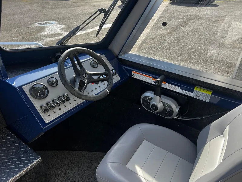 Slide: The Image of 2024 Thunder Jet 185 Luxor boat cockpit with steering wheel and control panel. - 11