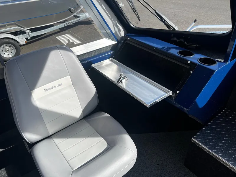 Slide: The Image of 2024 Thunder Jet 185 Luxor boat interior with gray seat and storage compartment. - 16
