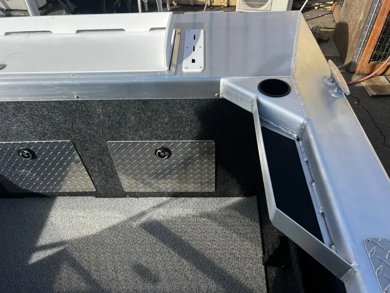 Slide: The Image of 2024 Thunder Jet 185 Luxor boat interior with storage compartments and cup holder. - 22