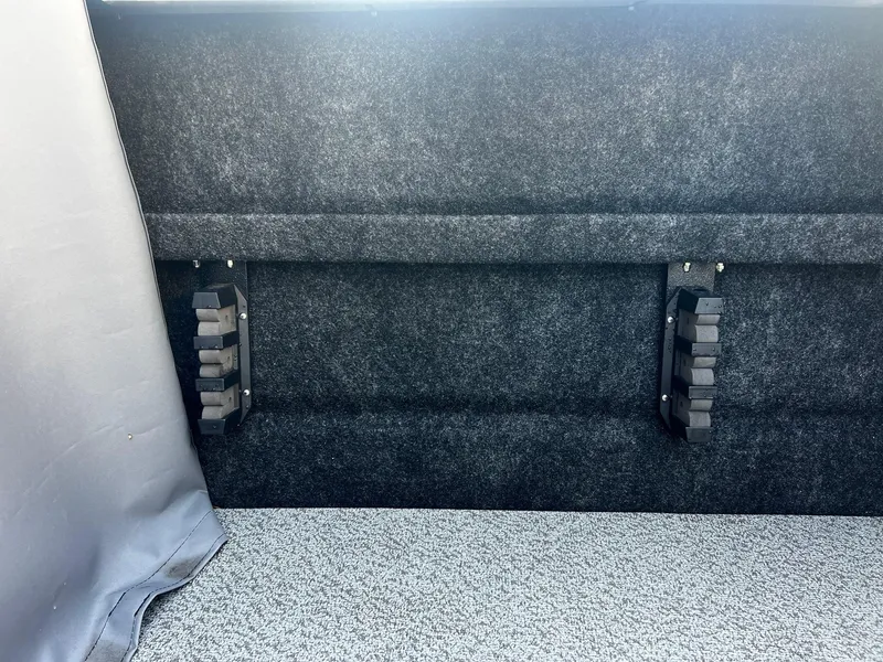 Slide: The Image of Interior of 2024 Thunder Jet 185 Luxor boat with carpeted flooring and storage compartments. - 24