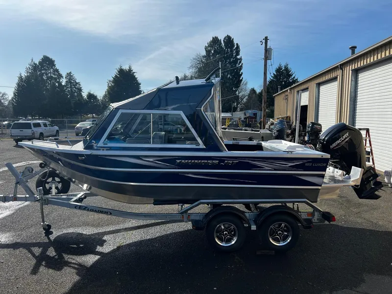 Slide: The Image of 2024 Thunder Jet 185 Luxor boat on a trailer in a parking lot. - 4
