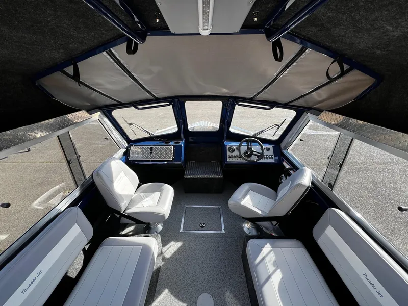 Slide: The Image of 2024 Thunder Jet 185 Luxor boat interior with seating and dashboard. - 8