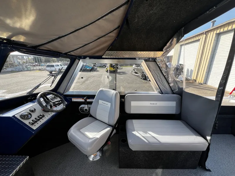 Slide: The Image of 2024 Thunder Jet 185 Luxor boat interior with seating and steering console. - 9