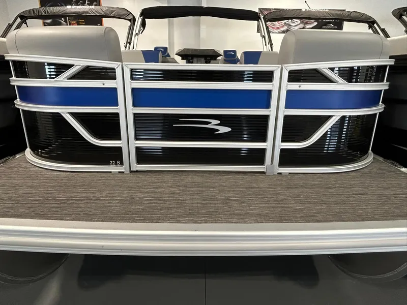Slide: The Image of 2024 Bennington 22SSB pontoon boat with sleek blue and black design. - 1
