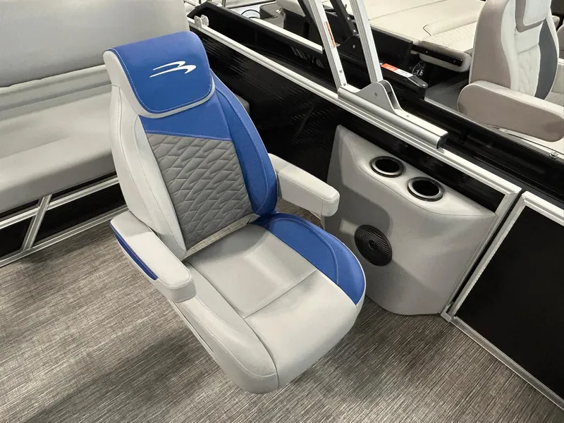 Slide: The Image of 2024 Bennington 22SSB boat seat with blue and gray upholstery, featuring cup holders and speaker. - 10