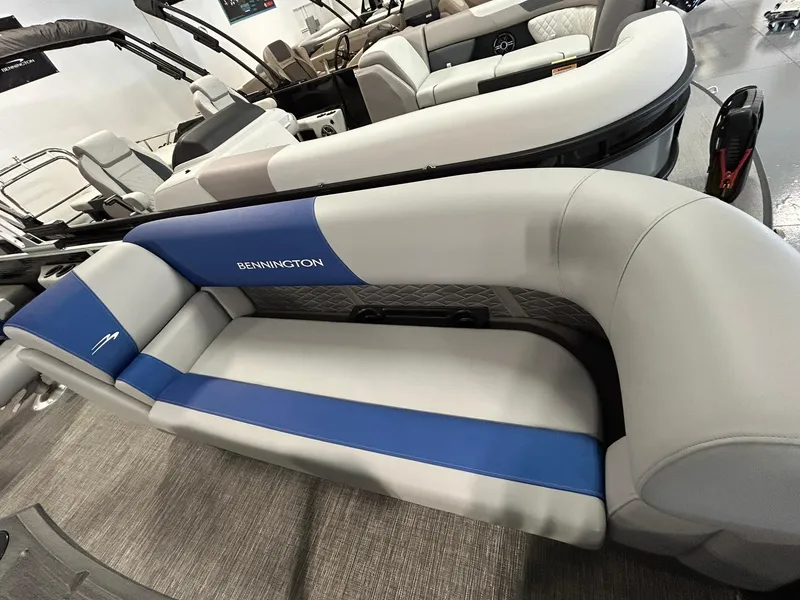 Slide: The Image of 2024 Bennington 22SSB boat interior with gray and blue seating, showcasing luxury design. - 5