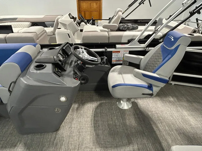 Slide: The Image of 2024 Bennington 22SSB boat interior with steering console and captain's chair. - 7