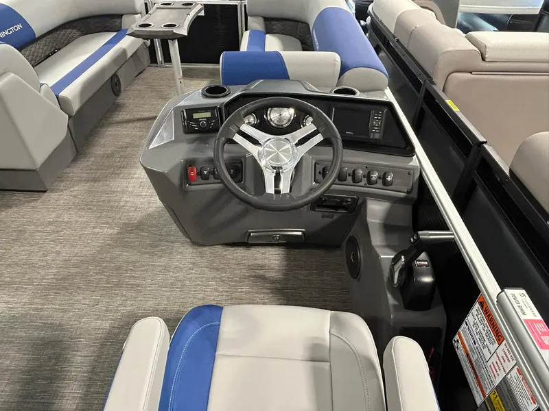 Slide: The Image of 2024 Bennington 22SSB boat interior with steering wheel and seating. - 8