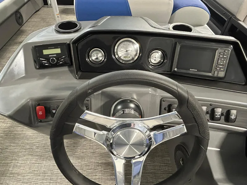 Slide: The Image of 2024 Bennington 22SSB boat dashboard with steering wheel, gauges, and control panel. - 9