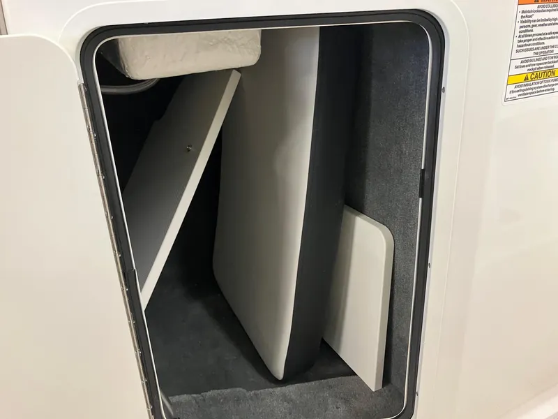 Slide: The Image of 2024 Sea Ray SPX 190 storage compartment with cushions and panels. - 10