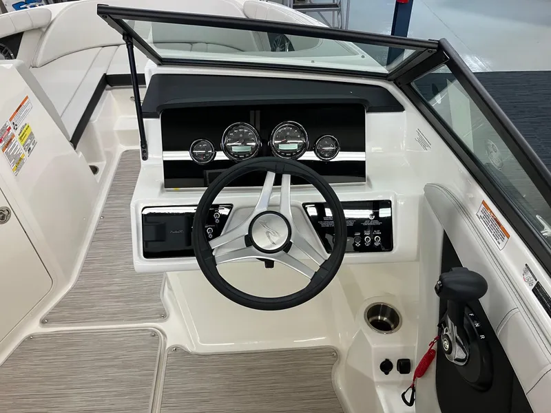 Slide: The Image of 2024 Sea Ray SPX 190 boat dashboard with steering wheel and control panel. - 6