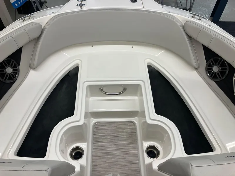 Slide: The Image of 2024 Sea Ray SPX 190 boat interior, featuring white seating and storage compartments. - 8