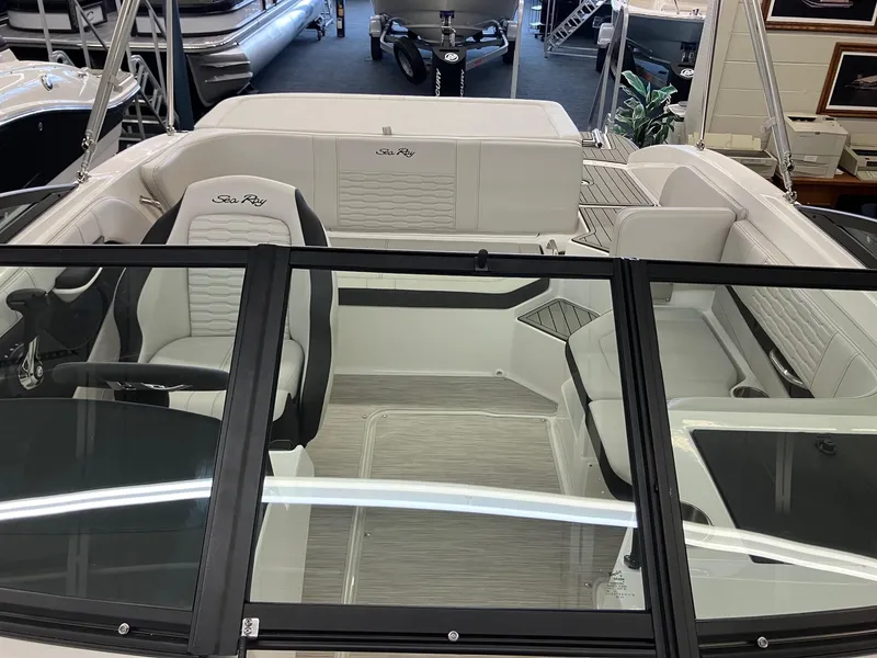 Slide: The Image of 2024 Sea Ray SPX 190 boat interior with white seating and black trim. - 9