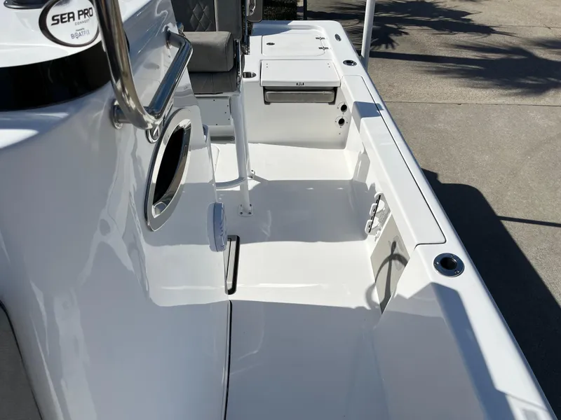 Slide: The Image of 2024 Sea Pro 230 Bay boat interior with seating and storage compartments. - 14