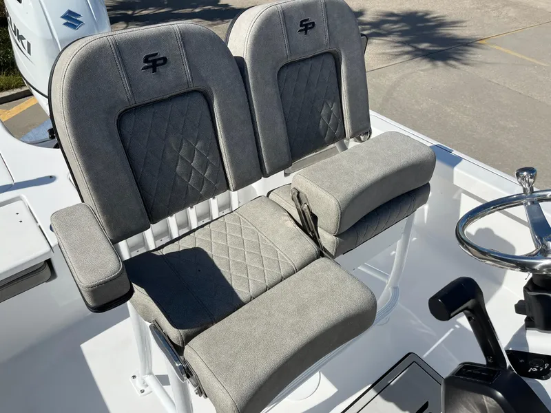 Slide: The Image of 2024 Sea Pro 230 Bay boat with dual cushioned seats and steering wheel. - 18