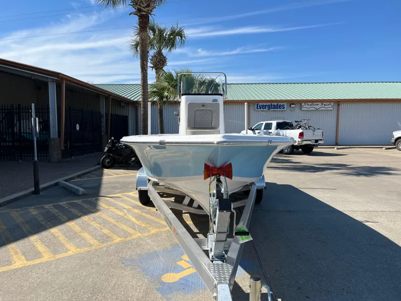 Slide: The Image of 2024 Sea Pro 230 Bay boat on a trailer in a parking lot. - 2