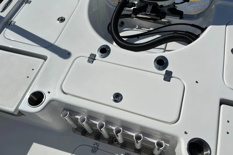 Slide: The Image of 2024 Sea Pro 230 Bay boat deck with storage compartments and rod holders. - 24