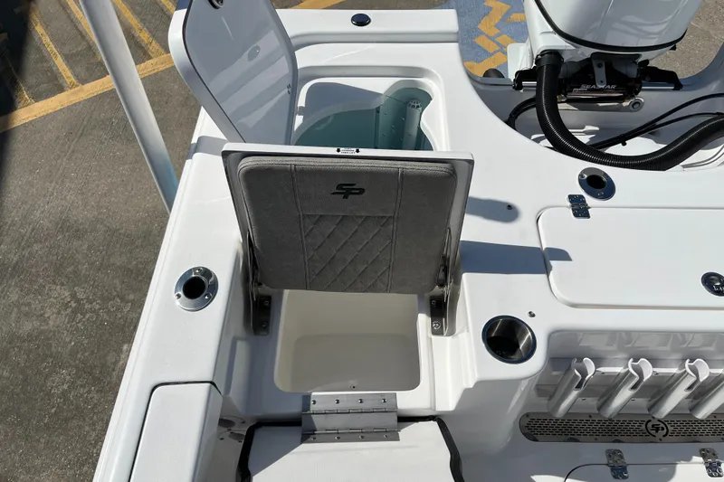 Slide: The Image of 2024 Sea Pro 230 Bay boat with open storage compartments and fishing rod holders. - 26