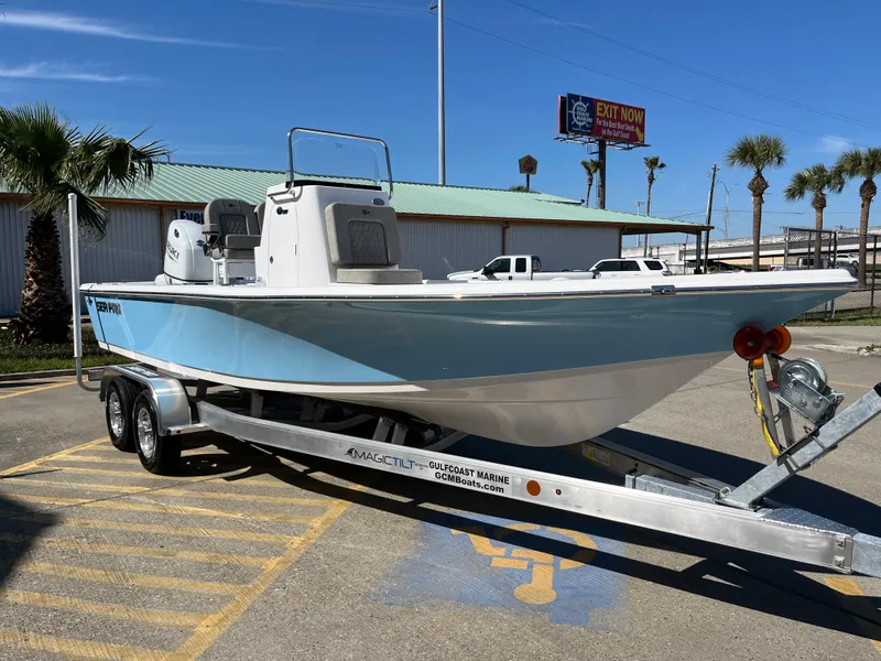 Slide: The Image of 2024 Sea Pro 230 Bay boat on a trailer in a parking lot. - 29