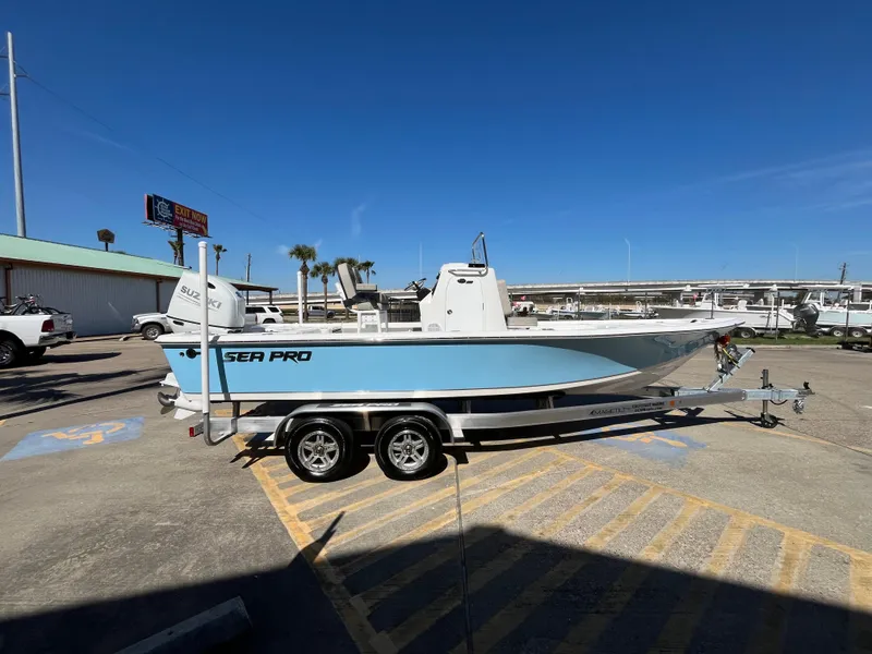 Slide: The Image of 2024 Sea Pro 230 Bay boat on a trailer in a parking lot. - 30