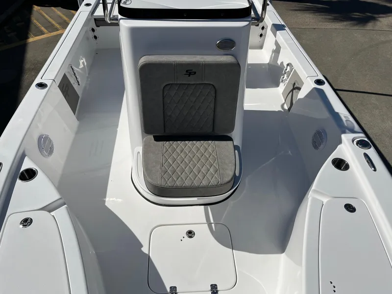Slide: The Image of 2024 Sea Pro 230 Bay boat interior with cushioned seating and storage compartments. - 36