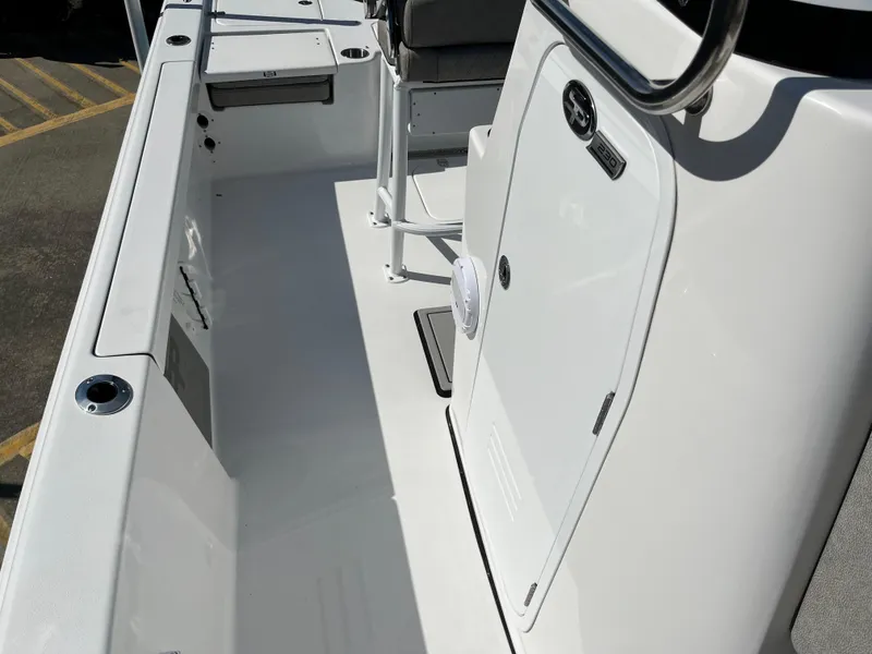 Slide: The Image of 2024 Sea Pro 230 Bay boat interior, featuring sleek white deck and seating. - 38