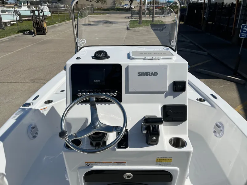Slide: The Image of 2024 Sea Pro 230 Bay boat console with steering wheel and Simrad electronics. - 41