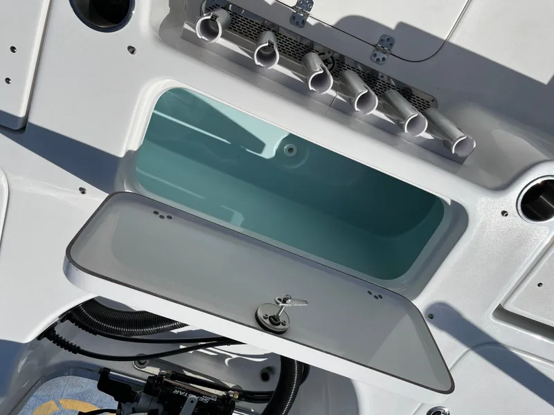 Slide: The Image of 2024 Sea Pro 230 Bay boat storage compartment and rod holders. - 47