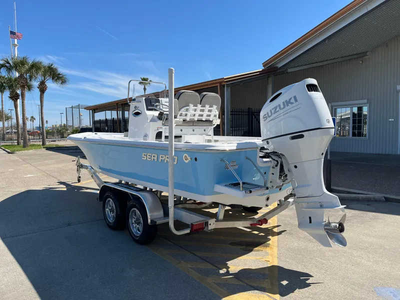 Slide: The Image of 2024 Sea Pro 230 Bay boat with Suzuki outboard motor on a trailer. - 7