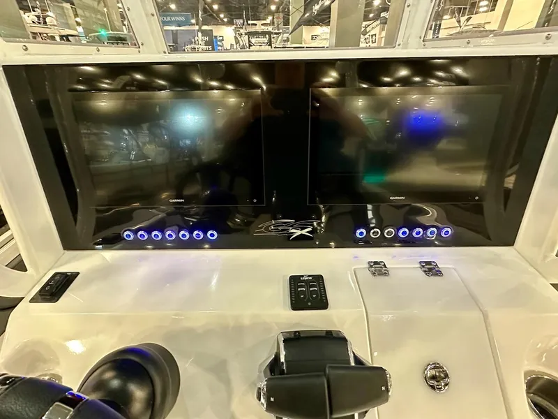 Slide: The Image of 2024 Glasstream 32 GSX boat dashboard with dual screens and illuminated controls. - 13