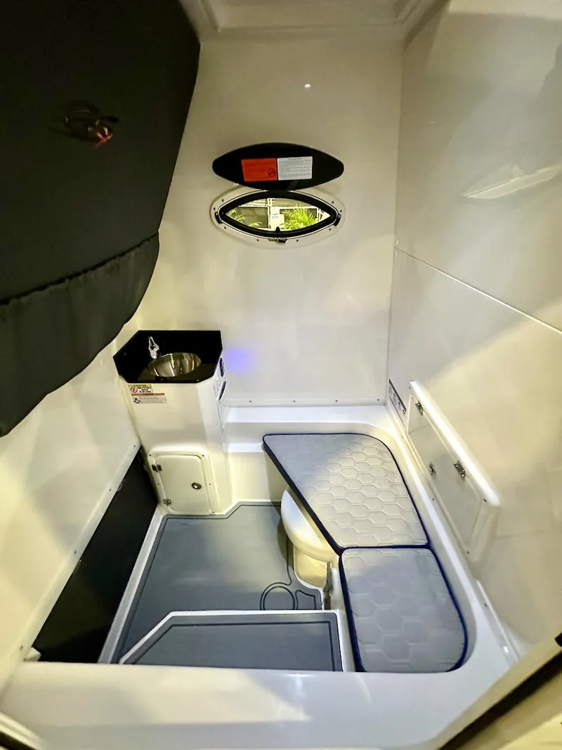 Slide: The Image of 2024 Glasstream 32 GSX cabin interior with seating, sink, and porthole window. - 20